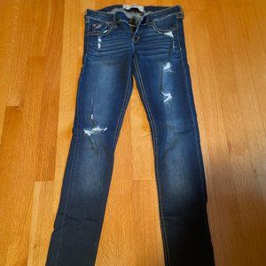 Distressed women's blue jeans